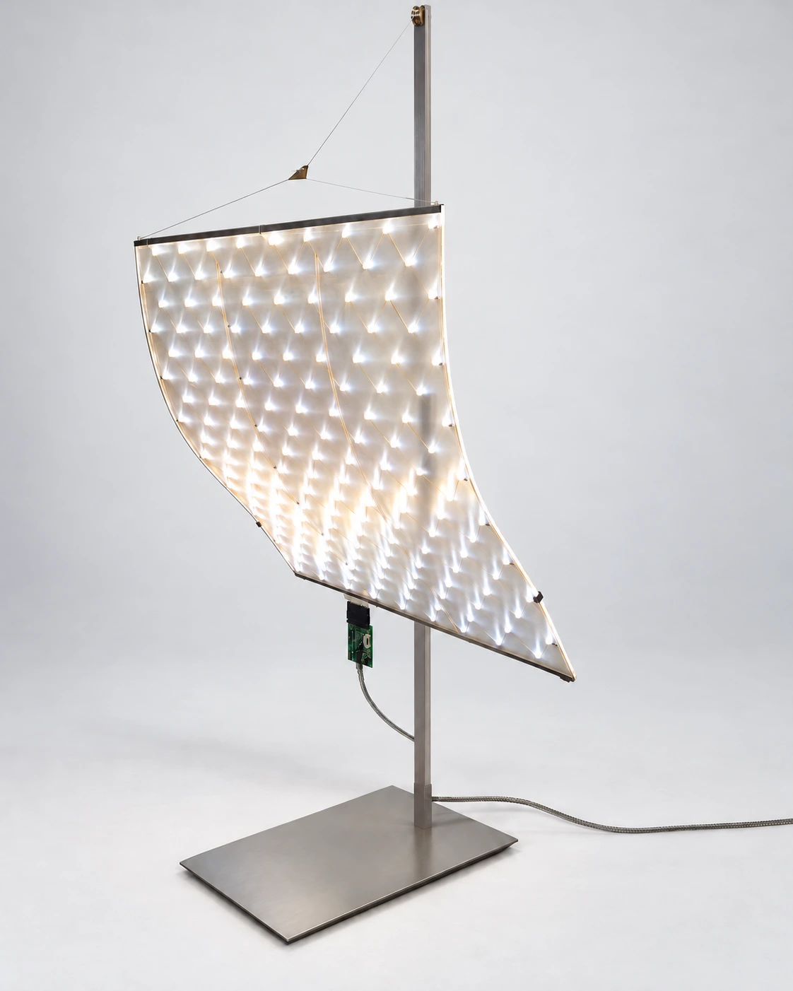 Front view of Vengco's Playing with its illuminated flexible LED sail suspended beside an anodised-aluminium mast